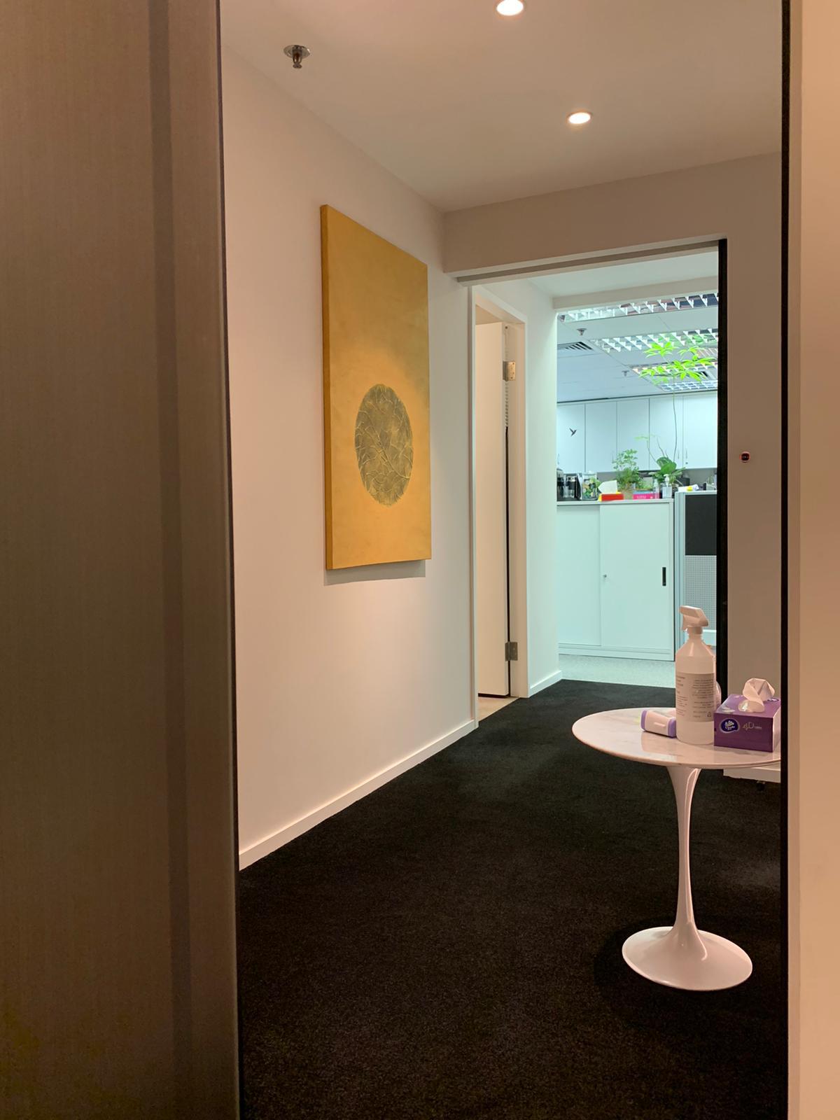 A calm, light-wood, uncluttered corridor in the MUJI style spirit at the Artwill studio